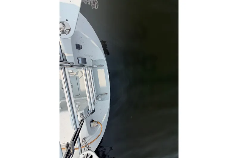 Slide: The Image of Top view of a 2003 Catalina 28 MkII sailboat's deck and ladder over water. - 10