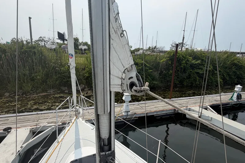 Slide: The Image of 2003 Catalina 28 MkII sailboat docked at marina, showing mast and rigging details. - 8