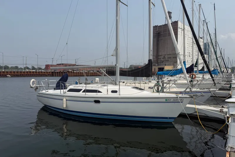 The Image of Sailboat Catalina 28 MkII 2003 docked in marina, calm water, urban backdrop. - 0
