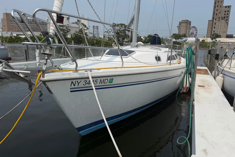 Slide: The Image of Catalina 28 MkII sailboat docked, 2003 model, with urban backdrop and marina setting. - 4