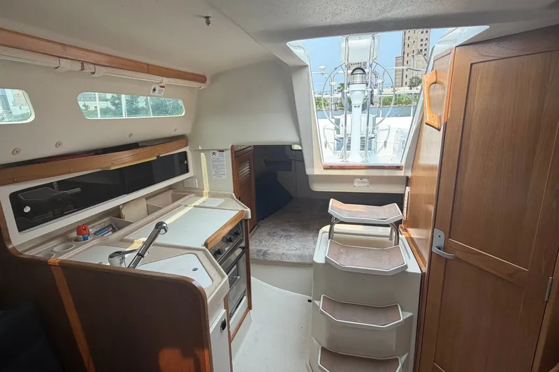 Slide: The Image of Interior of a 2003 Catalina 28 MkII sailboat with kitchen and stairs. - 22