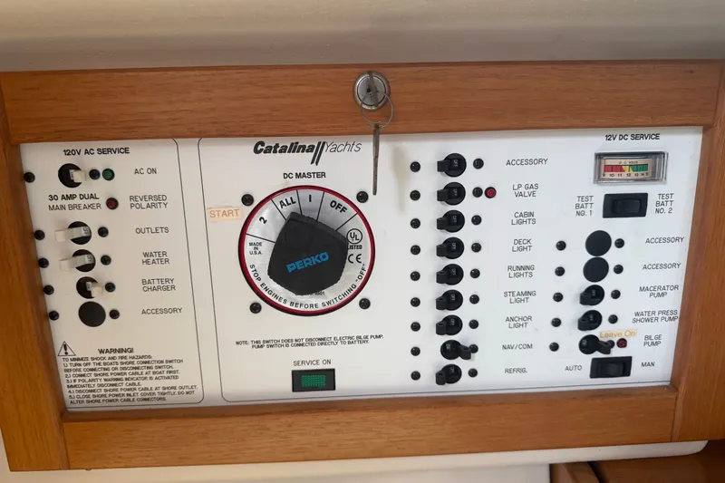 Slide: The Image of Control panel of a 2003 Catalina 28 MkII yacht with various switches and indicators. - 17