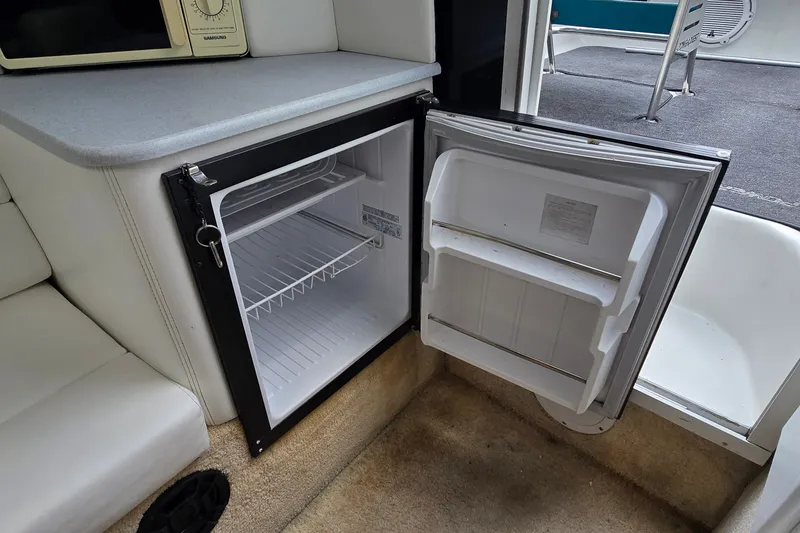 Slide: The Image of Open mini fridge inside a 1995 Powerquest 290 Enticer boat cabin. - 22