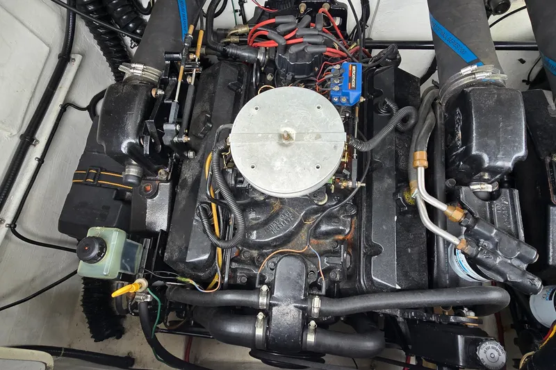 Slide: The Image of Engine of a 1995 Powerquest 290 Enticer boat, showcasing intricate mechanical components. - 25