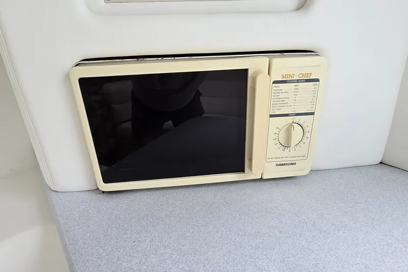 Slide: The Image of Samsung Mini Chef microwave in a 1995 Powerquest 290 Enticer boat interior. - 21