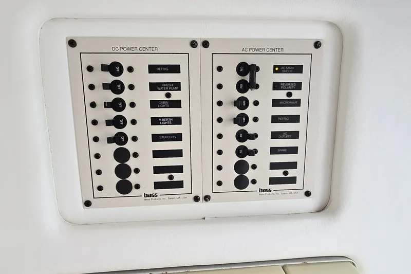 Slide: The Image of Powerquest 290 Enticer 1995 power control panel with DC and AC switches. - 20