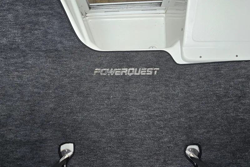 Slide: The Image of Carpeted interior of a 1995 Powerquest 290 Enticer boat with logo. - 16
