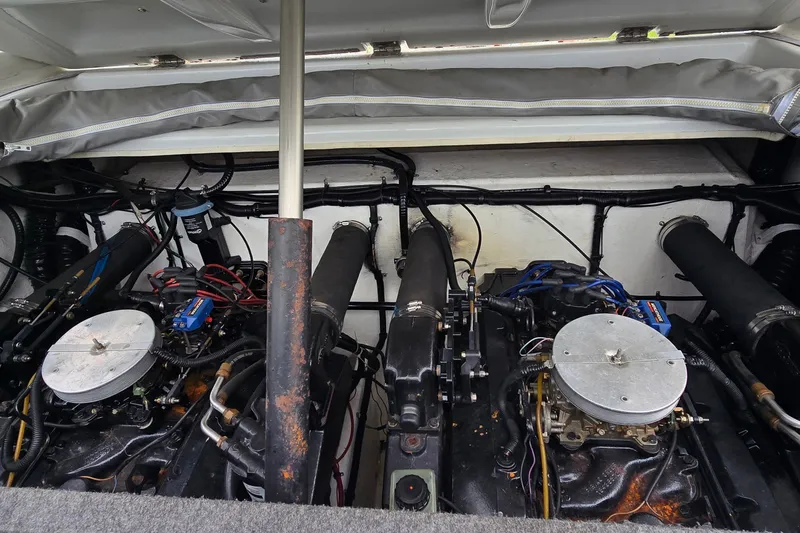 Slide: The Image of Engine compartment of a 1995 Powerquest 290 Enticer boat, showcasing dual engines. - 26