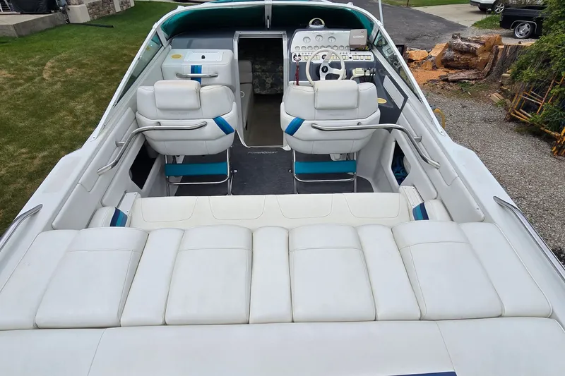 Slide: The Image of 1995 Powerquest 290 Enticer boat interior with white seating and steering console. - 9