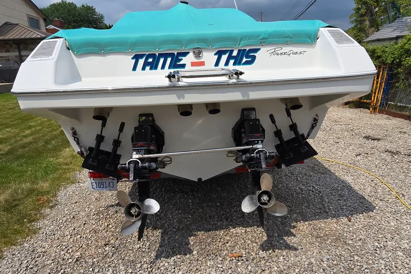 Slide: The Image of Rear view of a 1995 Powerquest 290 Enticer boat with dual propellers. - 2