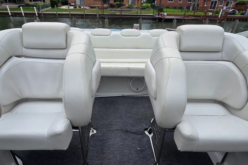 Slide: The Image of Interior of a 1995 Powerquest 290 Enticer boat with white seating. - 23