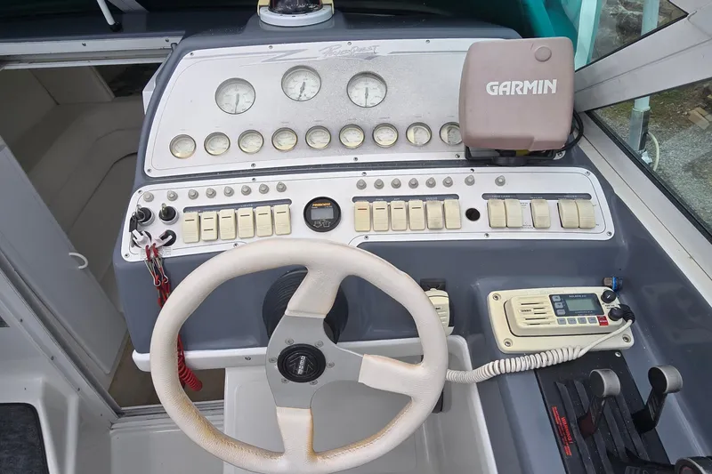 Slide: The Image of 1995 Powerquest 290 Enticer boat dashboard with Garmin GPS and control panel. - 14