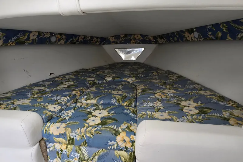 Slide: The Image of Interior cabin of 1995 Powerquest 290 Enticer with floral-patterned bedding. - 18