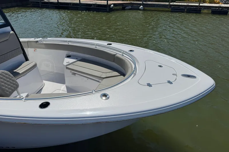 Slide: The Image of 2024 Sportsman Heritage 231 Center Console boat docked on calm water. - 3