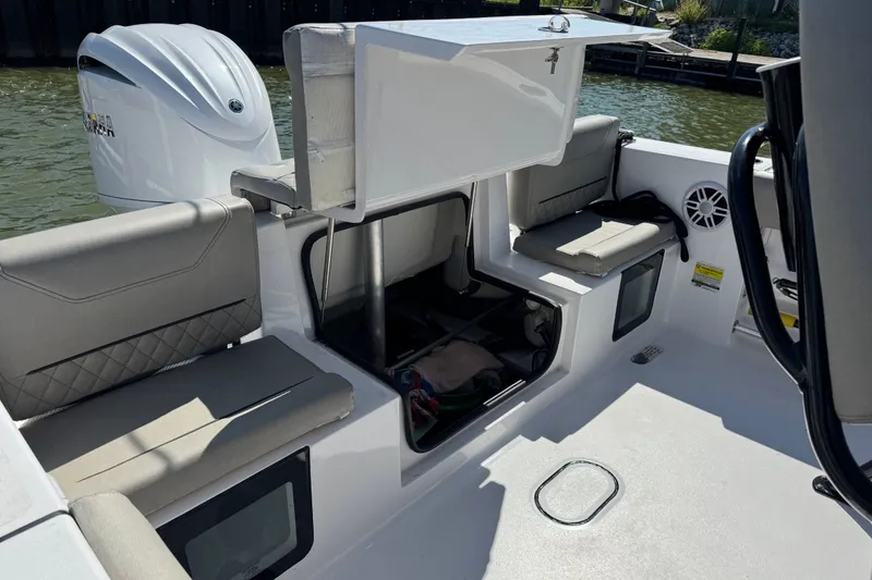 Slide: The Image of 2024 Sportsman Heritage 231 Center Console boat interior with seating and storage compartments. - 27