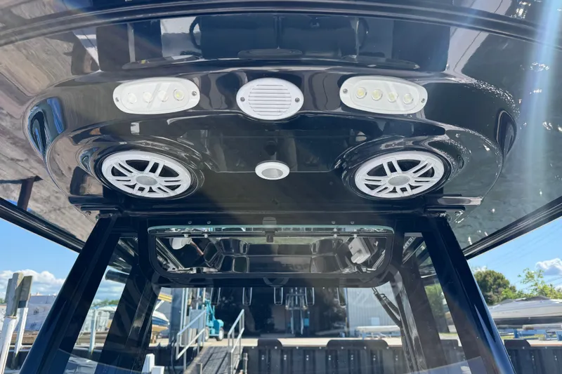 Slide: The Image of 2024 Sportsman Heritage 231 Center Console boat with speakers and lights on the T-top. - 23