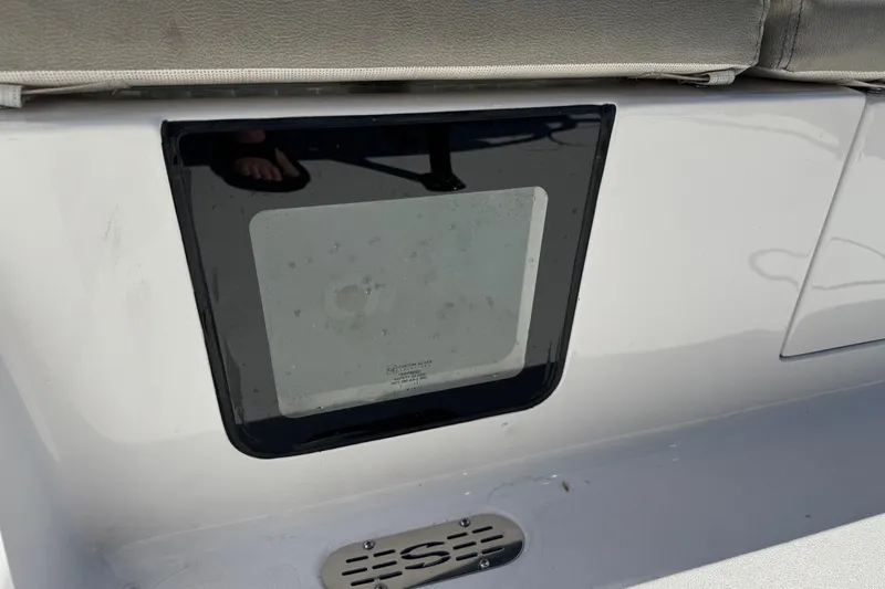 Slide: The Image of 2024 Sportsman Heritage 231 Center Console boat detail with seating and storage compartment. - 25