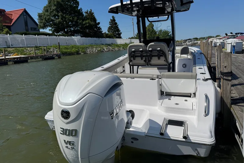 Slide: The Image of 2024 Sportsman Heritage 231 Center Console boat docked, featuring a powerful 300 V6 engine. - 5
