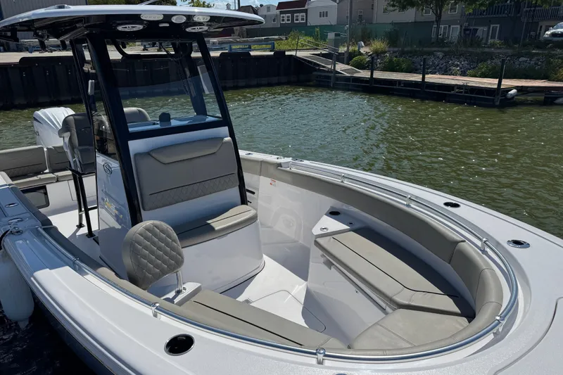 Slide: The Image of 2024 Sportsman Heritage 231 Center Console boat docked, featuring spacious seating and modern design. - 2