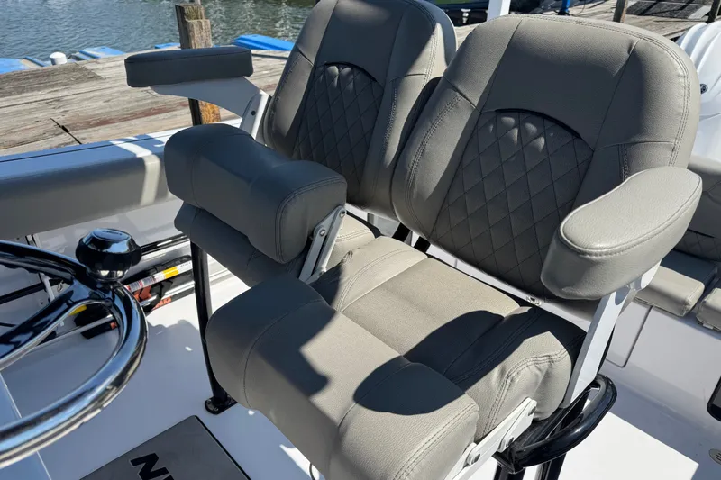 Slide: The Image of 2024 Sportsman Heritage 231 Center Console boat seats with diamond stitching and armrests. - 10