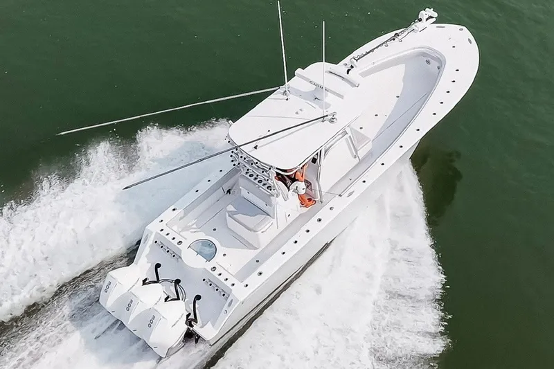 Slide: The Image of 2018 Onslow Bay 33 Tournament Edition boat cruising on open water. - 10