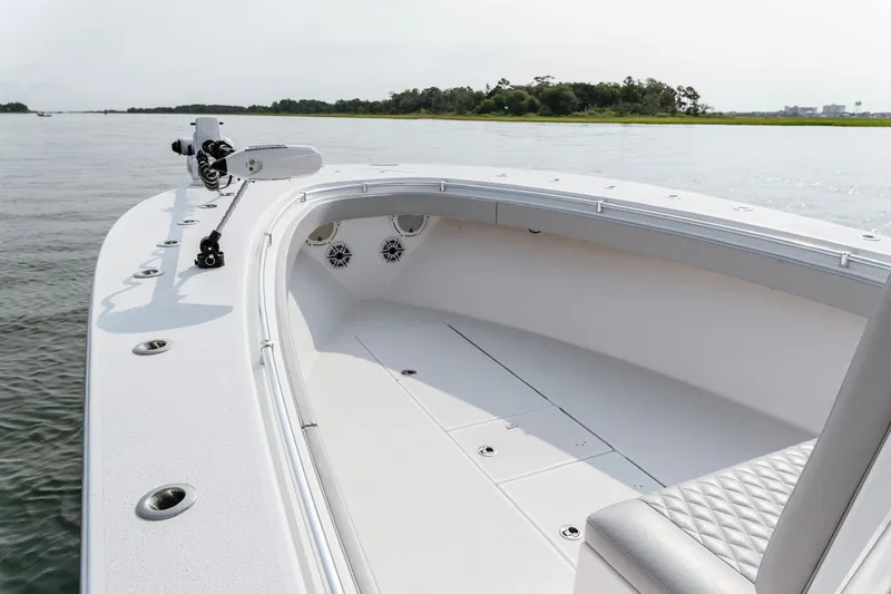 Slide: The Image of 2018 Onslow Bay 33 Tournament Edition boat on calm water, showcasing spacious deck. - 16
