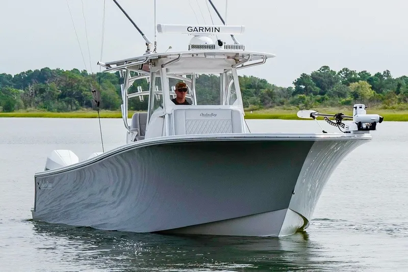 Slide: The Image of 2018 Onslow Bay 33 Tournament Edition boat on calm water, featuring Garmin equipment. - 8