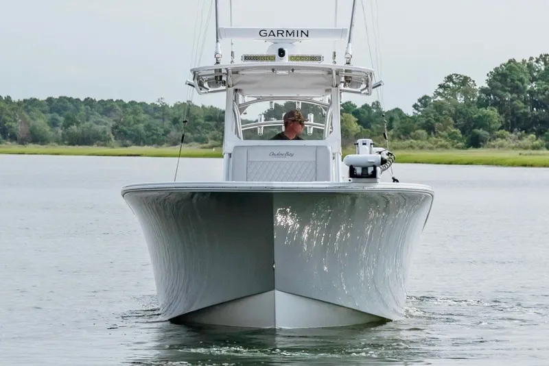 Slide: The Image of 2018 Onslow Bay 33 Tournament Edition boat on calm water, front view. - 5