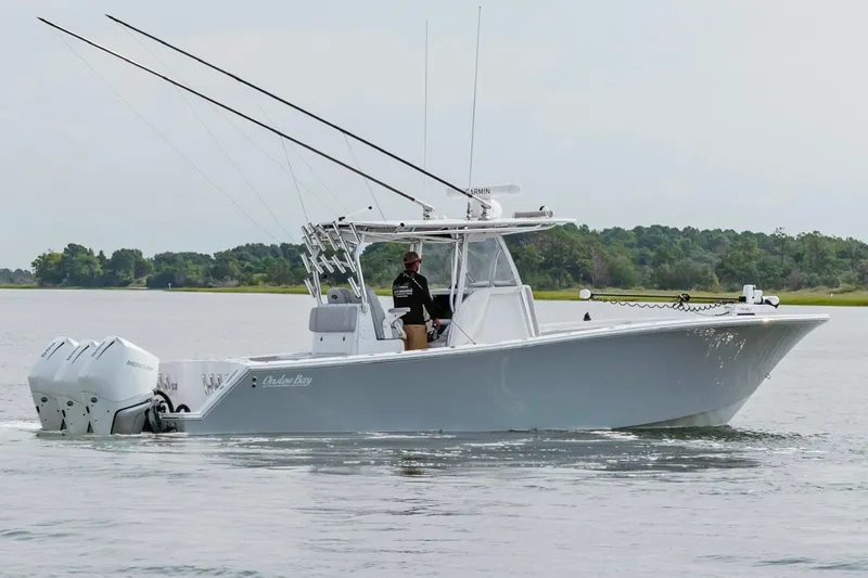 Slide: The Image of 2018 Onslow Bay 33 Tournament Edition boat cruising on calm waters. - 2