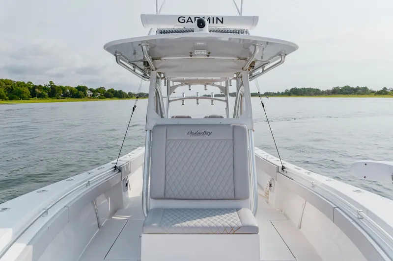 Slide: The Image of 2018 Onslow Bay 33 Tournament Edition boat on calm water, featuring Garmin equipment. - 15