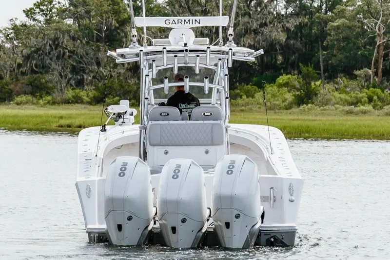 Slide: The Image of 2018 Onslow Bay 33 Tournament Edition boat with triple engines on a calm waterway. - 3