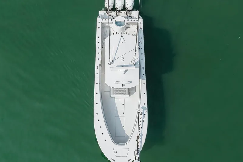 Slide: The Image of Overhead view of 2018 Onslow Bay 33 Tournament Edition boat on green water. - 11