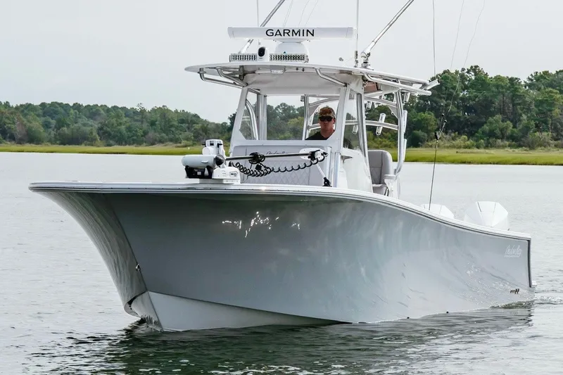 Slide: The Image of 2018 Onslow Bay 33 Tournament Edition boat cruising on calm water. - 6