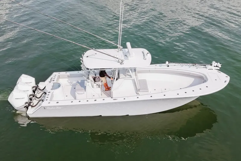 Slide: The Image of 2018 Onslow Bay 33 Tournament Edition boat on water, featuring triple Mercury engines. - 9