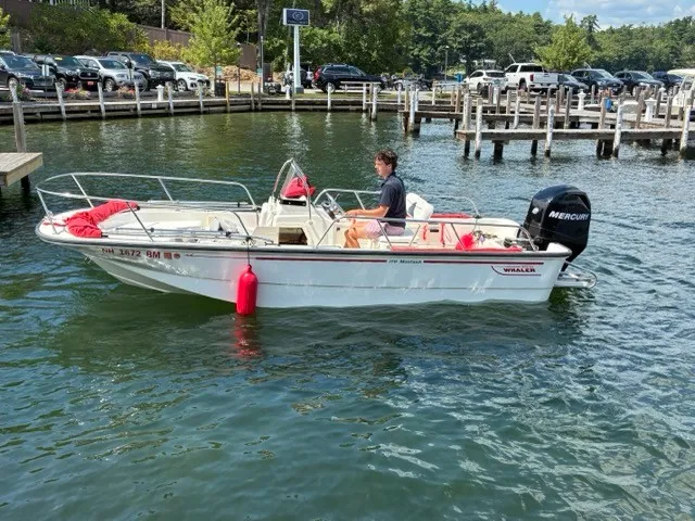 The Image of A 2007 Boston Whaler 170 Montauk on a lake. A man is steering the boat. - 2
