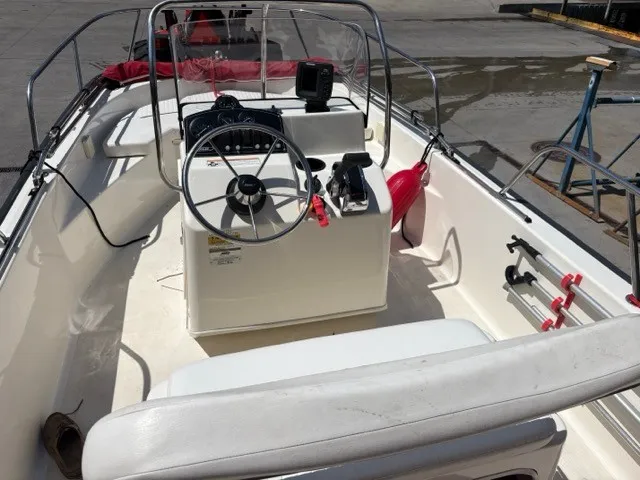 Slide: The Image of The image shows the cockpit of a 2007 Boston Whaler 170 Montauk with a helm console and seating. - 6