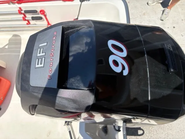 Slide: The Image of An outboard motor labeled "EFI FourStroke 90" is mounted on a boat. - 9