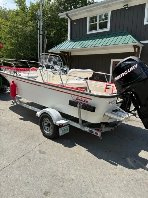 Slide: The Image of A 2007 Boston Whaler 170 Montauk on a trailer. It features a Mercury outboard motor. - 1
