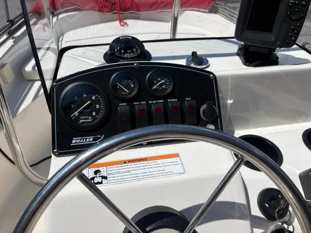 Slide: The Image of The image shows the helm of a 2007 Boston Whaler 170 Montauk with instruments and steering wheel. - 7