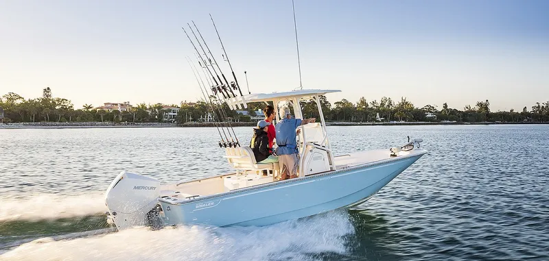The Image of A 2027 Boston Whaler 210 Montauk cruising on calm water. Two people are standing on board. - 1