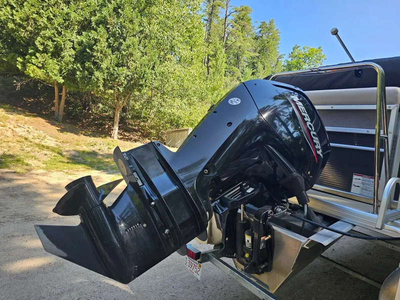 Slide: The Image of A Mercury outboard motor is mounted on a Princecraft Vectra 21 boat, surrounded by trees. - 5