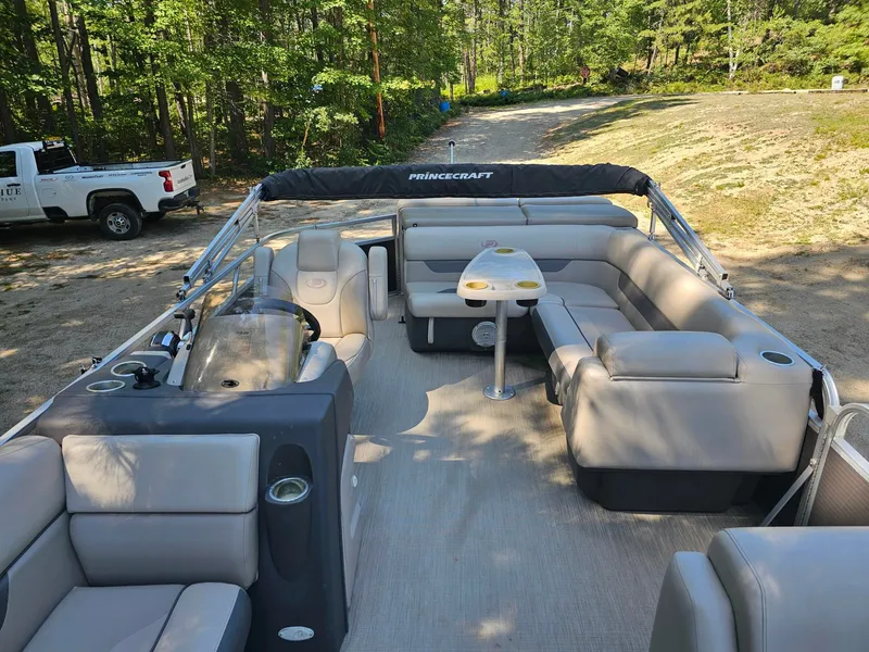 Slide: The Image of A 2019 Princecraft Vectra 21 pontoon boat with gray seating and a central table. - 8