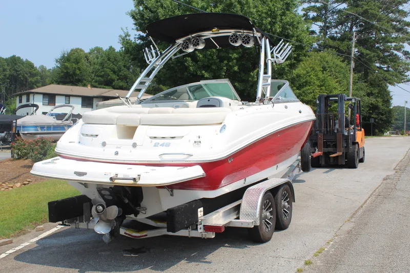 Slide: The Image of A 2007 Chaparral 246 SSi boat on a trailer, ready for transport. It features a red and white design. - 8