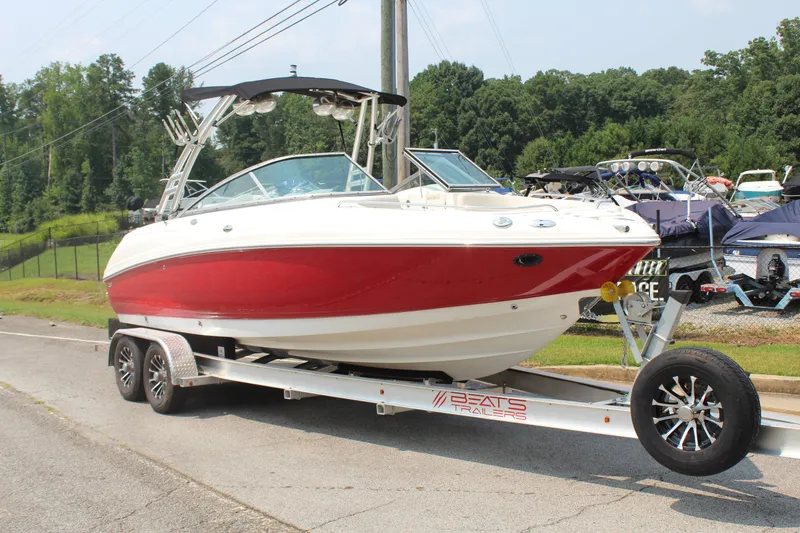 Slide: The Image of A red 2007 Chaparral 246 SSi boat sits on a trailer by the roadside. - 7