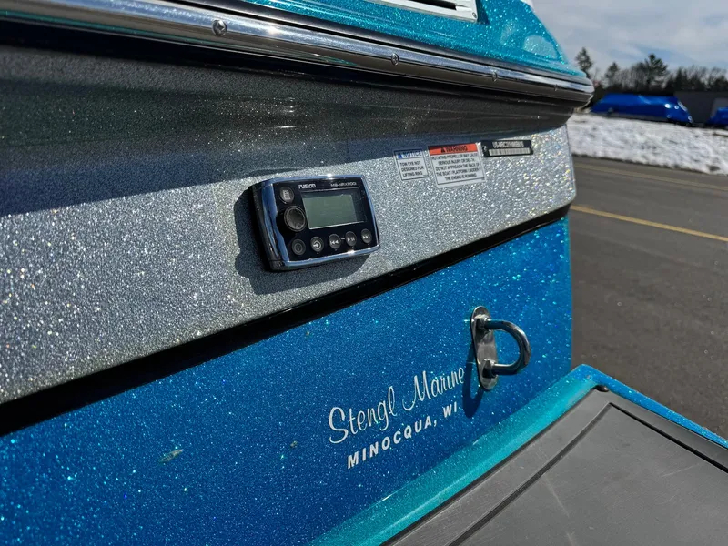 Slide: The Image of Close-up of a blue 2016 MasterCraft X10 boat with glittery paint and a control panel. - 12