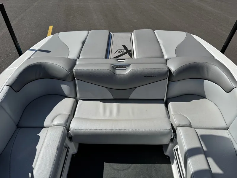 Slide: The Image of The image shows the gray and white upholstery of a MasterCraft X10 boat's rear seating area. - 22