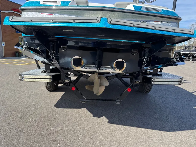 Slide: The Image of The image shows the rear of a blue 2016 MasterCraft X10 boat on a trailer. - 11