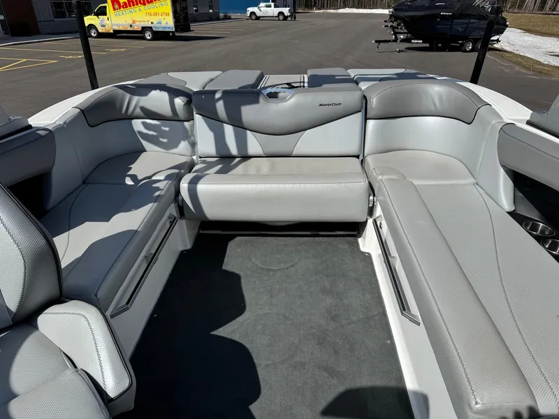 Slide: The Image of The image shows the gray and white seating area of a 2016 MasterCraft X10 boat. - 21