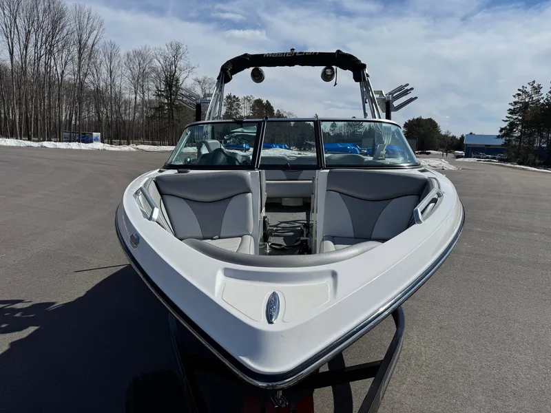 Slide: The Image of A white 2016 MasterCraft X10 boat on a trailer in a parking lot. - 13