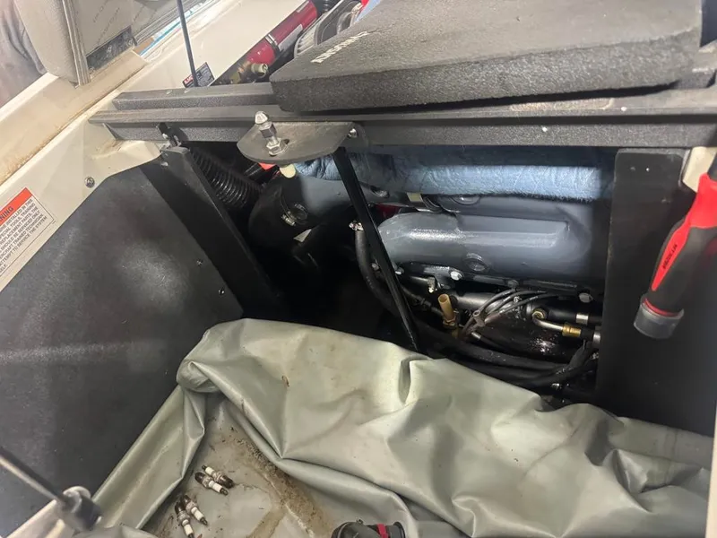 Slide: The Image of The engine compartment of a 2016 MasterCraft X10 showing the engine and some tools. - 32